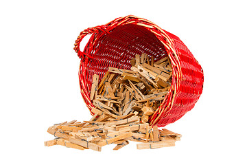 Image showing Very old red basket with wooden clothespins