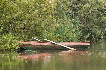 Image showing Red rowing boat on lake