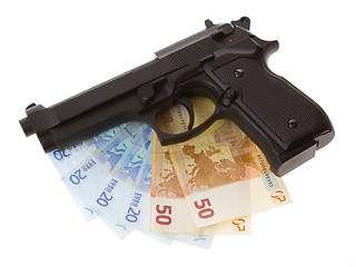 Image showing Semi-automatic gun and money isolated