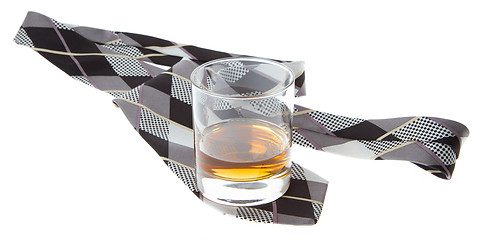 Image showing Glass of whisky and a tie