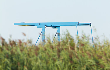 Image showing Blue drawbridge hidden in the reeds