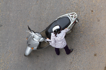 Image showing Top view of a woman holding a grey scooter