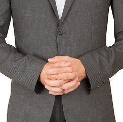 Image showing Business man in grey suit praying