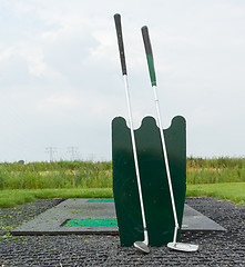 Image showing Two golf clubs standing