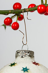 Image showing Very old silver christmas ball hanging from a twig (butchers bro