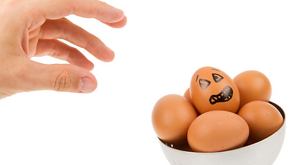 Image showing Scared egg, waiting to be grabbed by a hand