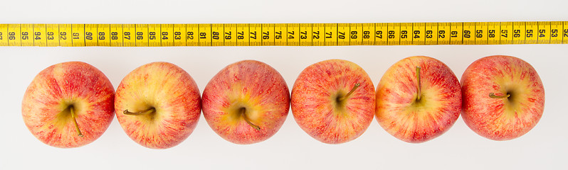 Image showing Red apples with a yellow tape-measure