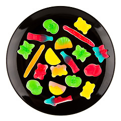 Image showing Colorful candies in many different shapes isolated on a black pl