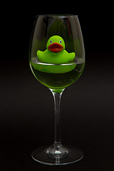 Image showing Green rubber duck in a wineglass