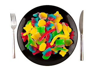 Image showing Colorful candies in many different shapes isolated on a black pl
