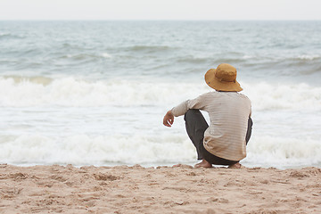 Image showing Man sitting on the beach at the south chinese sea 