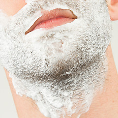 Image showing Close-up of a young man shaving