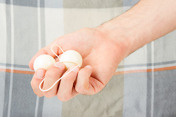 Image showing Hand holding white vaginal balls, isolated