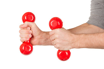 Image showing Red dumbbells in the hands of a man, isolated