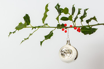 Image showing Very old silver christmas ball hanging from a twig (butchers bro