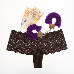 Image showing Fluffy purple handcuffs, panties and money, prostitution