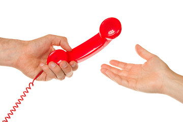 Image showing Man giving red telephone to woman