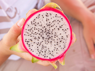 Image showing Woman holding a dragon fruit