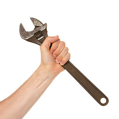 Image showing Old rusted adjustable vector wrench in a hand