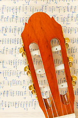 Image showing Old music sheet and a guitar