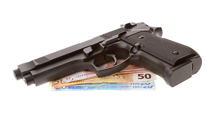 Image showing Semi-automatic gun with some euro bills isolated