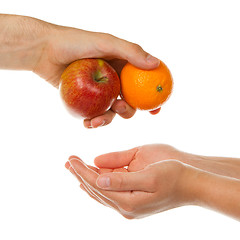 Image showing Giving an apple and an orange