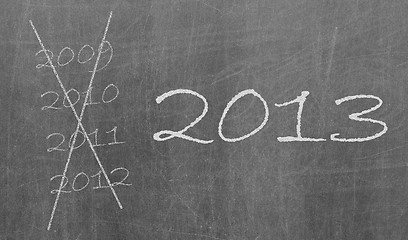 Image showing 2009, 2010 and 2012 crossed and new year 2013 written on chalkbo