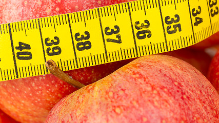 Image showing Red apples with a yellow tape-measure