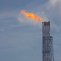 Image showing Burning oil gas flare during sunset 