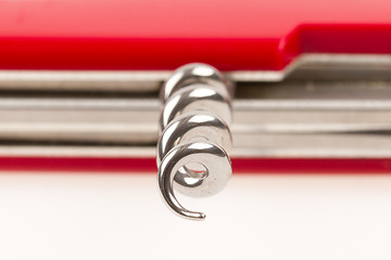 Image showing Red swiss army knife isolated, focus on corkscrew