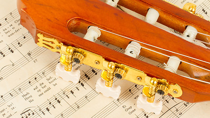 Image showing Old music sheet and a guitar