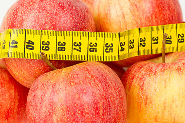 Image showing Red apples with a yellow tape-measure