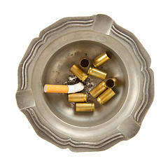 Image showing Empty 9mm bullet casings in an old tin ashtray