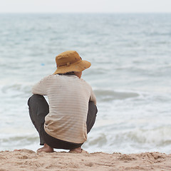 Image showing Man sitting on the beach at the south chinese sea 