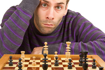 Image showing Chessboard with desperate man thinking about chess strategy, iso