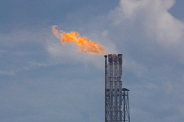 Image showing Burning oil gas flare during sunset 