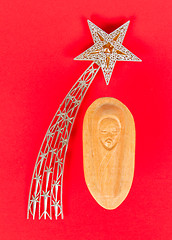 Image showing Falling star, christmas decoration and a carving of the baby Jez