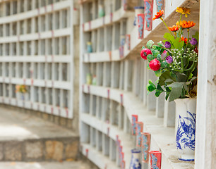 Image showing Collection of fake plastic flowers at a cemetary