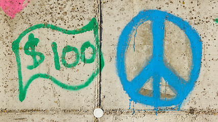 Image showing Simple graffity on a concrete wall, dollar and piece sign