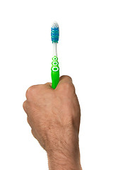 Image showing Man holding a green toothbrush