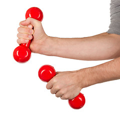 Image showing Red dumbbells in the hands of a man, isolated