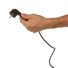 Image showing Hand holding a plug in