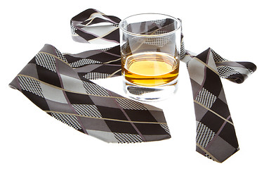 Image showing Glass of whisky and a tie