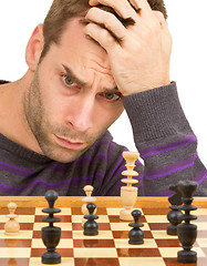 Image showing Chessboard with desperate man thinking about chess strategy, iso