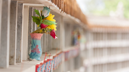 Image showing Collection of fake plastic flowers at a cemetary