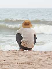 Image showing Man sitting on the beach at the south chinese sea 