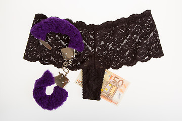 Image showing Fluffy purple handcuffs, panties and money, prostitution