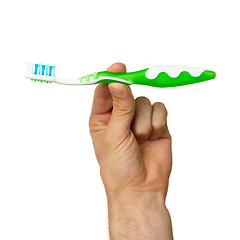 Image showing Man holding a green toothbrush