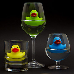 Image showing Green, yellow and blue rubber duck in different glasses