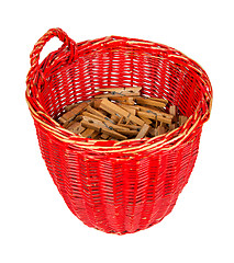 Image showing Very old red basket with wooden clothespins